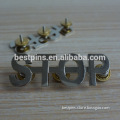 metal silver "stop" logo with screw